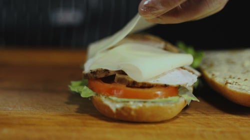 Assembling Fresh Sandwich with Cheese and Turkey