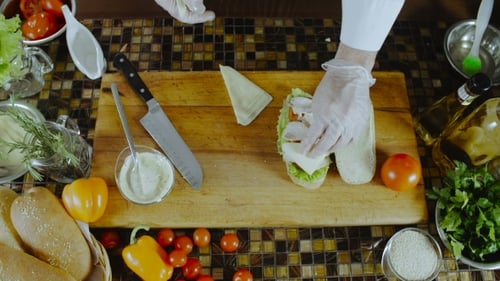 Chef Prepares Gourmet Sandwich with Fresh Ingredients