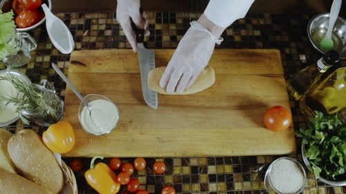Chef Cutting Sesame Seed Bun for Sandwich Prep