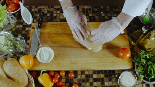 Chef Wrapping Sandwich with Paper and String