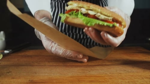 Wrapping Delicious Sandwich on Cutting Board