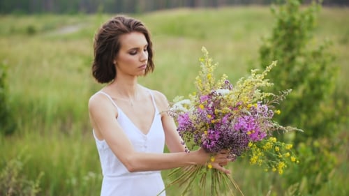 Summer Flowering Field And a Beautiful Girl In a White Sundress.