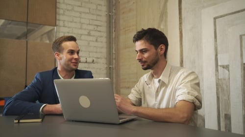 Two Men Working Together in Modern Office