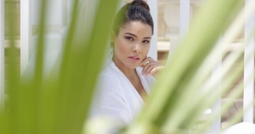 Elegant Woman Posing Through Tropical Foliage