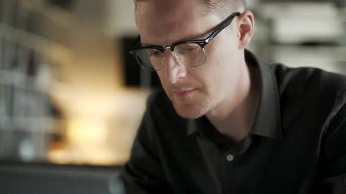 Young Man Freelancer Using Laptop Online Working From Office In Internet, Smiling Focused Millennial