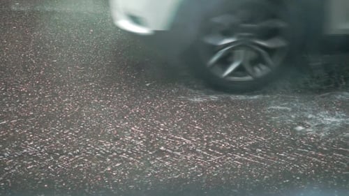 Car Passing By On Rainy Asphalt. Video