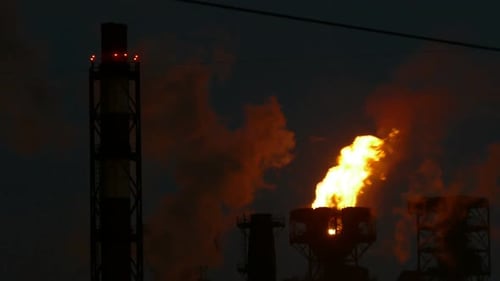 Burning Torch and Smoke at the Metallurgical Plant