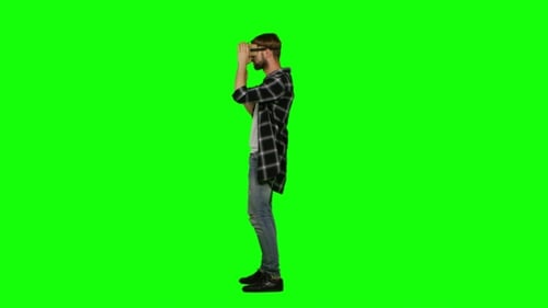 Virtual Reality Gamer Playing With a VR Headset. Green Screen