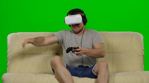 Young Adult Plays VR Game on Couch