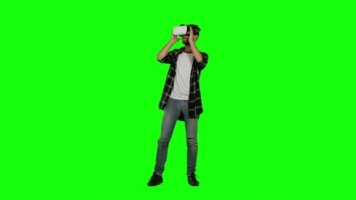 Man Wearing Virtual Reality Goggles. Studio Shot. Green Screen