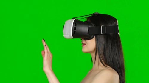 Virtual Reality Game. Girl With Surprise And Pleasure Uses Head-mounted Display. Green Screen.