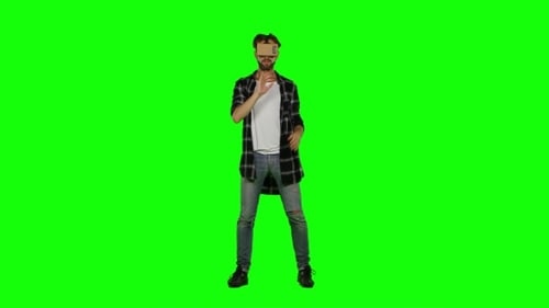 Young Man With VR Virtual Reality Headset On His Head. Green Screen