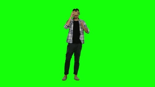 Young Man Uses VR Headset on Green Screen