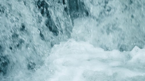 Clear water cascading down a rock face