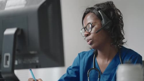 Medical Professional Working and Speaking with Headset