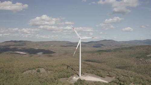 Wind Turbine Rotating on Rural Hillside