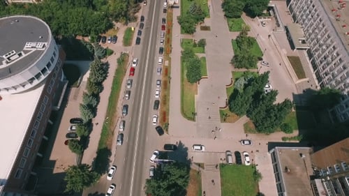 Camera Is Flying From Quiet Square And Road To Golden Beach Near River