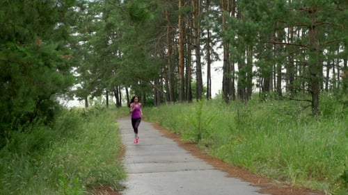 Girl Runs Through Park In The Morning