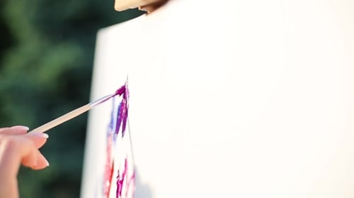 Hand Paints Colorful Abstract Image on Canvas