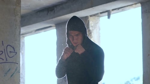 Young Man Boxing in Derelict Urban Environment