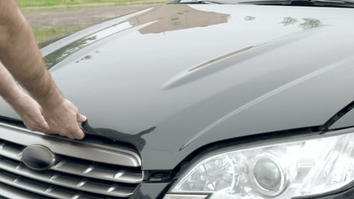 Auto Mechanic Opens The Car Hood Motor Engine