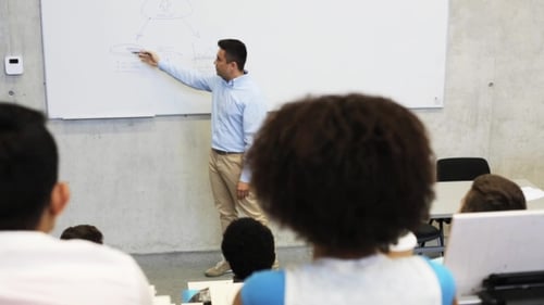 College Professor Lecturing to Students in Classroom