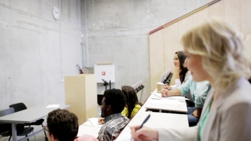 College Students Listening to a Lecture in Hall