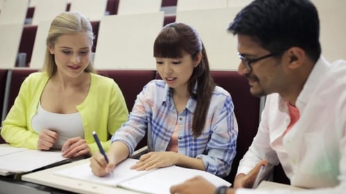 Group Of Students With Notebooks In Lecture Hall