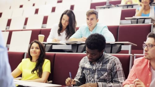 Group Of Students With Notebooks In Lecture Hall