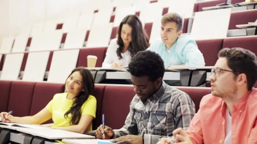 Students Attending Lecture Taking Notes in Classroom
