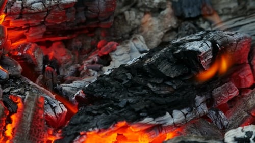 Burning Embers and Flickering Flames Close Up