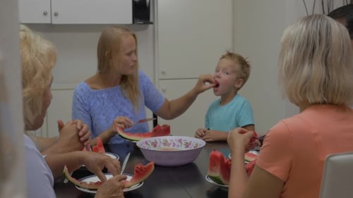 Family Enjoys Eating Watermelon Together