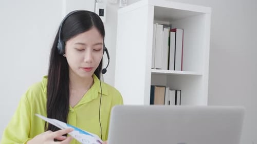 Woman Presenting Graphs via Laptop