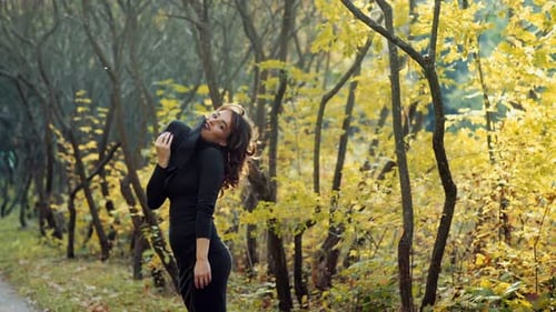 Woman relaxing in park. Happy attractive woman relaxing in sunny autumn park