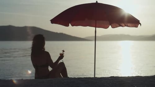A Girl Drinking a Cocktail at an Exotic Resort