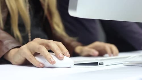 Blonde Woman Using Computer Mouse in Office