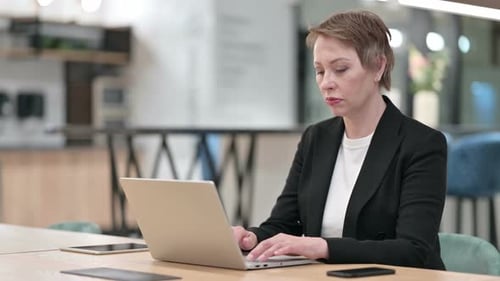 Stressed Old Businesswoman Having Headache in Office