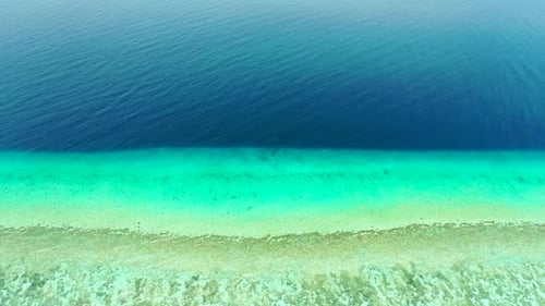 Aerial top down nature of tranquil coast beach trip by blue green sea with white sand background of
