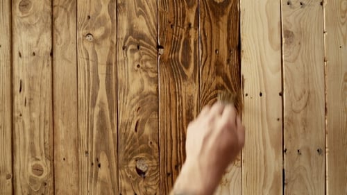 Staining Wooden Wall with Brush for Home Improvement
