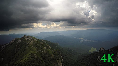 Aerial View of Green Mountains Under Dramatic Sky