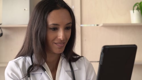 Doctor Uses Tablet for Telehealth Consultation