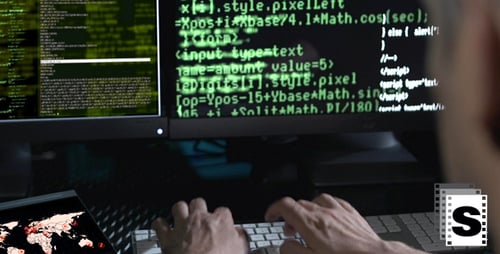Programmer Typing Code at His Desk