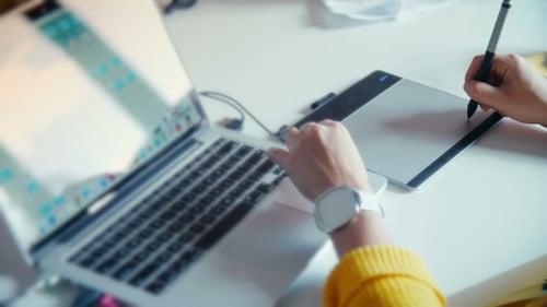 Designer Working on Laptop and Drawing Tablet