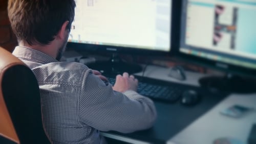 Man Working At Computer In Contemporary Office