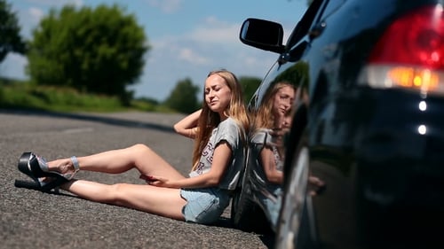 Blonde Girl Sitting On Road Near Her Broken Car
