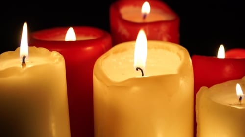 Burning Candles Glowing Softly in the Dark