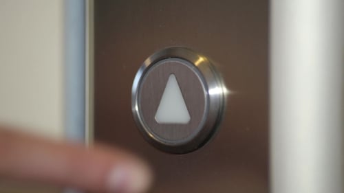 Pressing Up Arrow At Elevator.