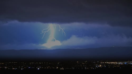 Lightning Flashes Over City at Night