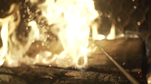 Close-up of Warm Fireplace with Burning Logs