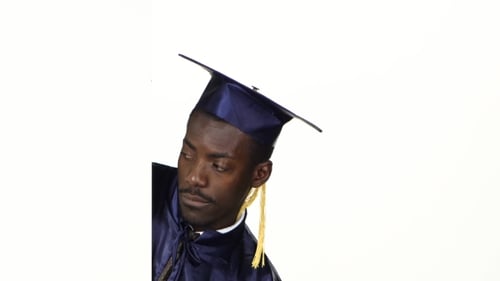 Graduate Peeks Out From Behind a Corner And Shows a Finger Down. White.